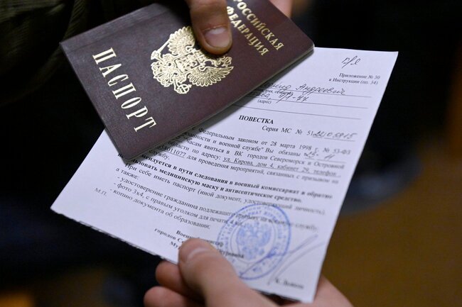 Мурманская область. Североморск. Паспорт с повесткой в руках призывника на сборном пункте военкомата. Осенняя призывная кампания началась в России на месяц позже обычного из-за загруженности военкоматов в связи с мероприятиями в рамках частичной мобилизации. С 1 ноября по 31 декабря в России пройдет осенний призыв на срочную службу, в рамках которого будут призваны 120 тыс. человек, при этом в зону проведения специальной военной операции они направляться не будут. Лев Федосеев/ТАСС